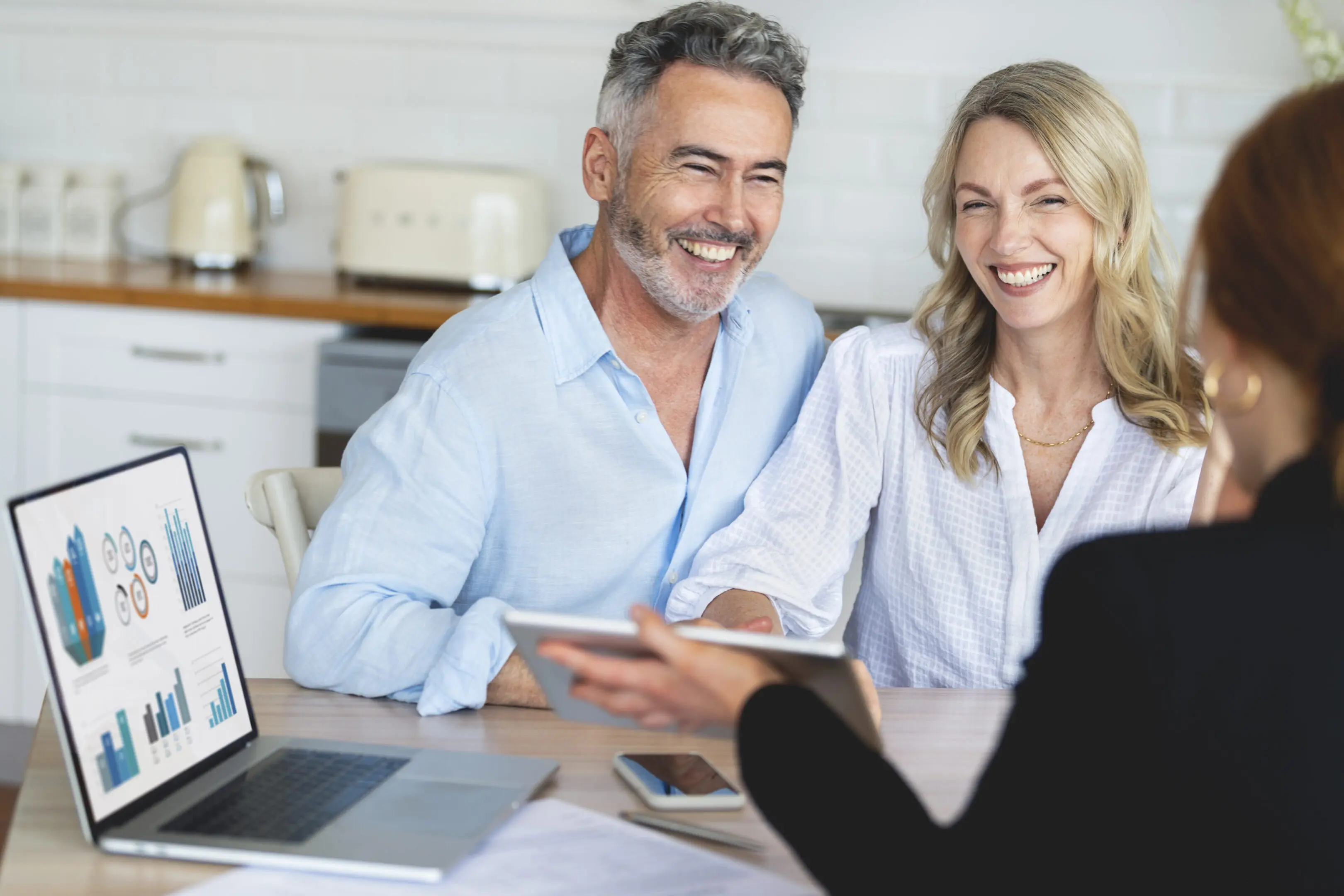 Couple smiling during a financial consultation.